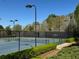 Outdoor community tennis courts surrounded by trees and landscaping at 3570 Terrasol Sw Trl, Lilburn, GA 30047