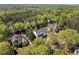 High-angle aerial shot showcasing the neighborhood's lush canopy, highlighting the modern home's location at 1395 Oconee Ne Pass, Brookhaven, GA 30319