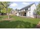 Expansive backyard showing the home's exterior, covered patio and manicured lawn in a suburban setting at 1395 Oconee Ne Pass, Brookhaven, GA 30319