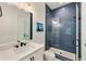 Modern bathroom showcasing blue herringbone tile shower and sleek white vanity at 1395 Oconee Ne Pass, Brookhaven, GA 30319