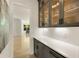 Convenient butler pantry with gray cabinets, glass displays, a white countertop, and subway tile backsplash at 1395 Oconee Ne Pass, Brookhaven, GA 30319