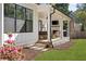 Side view of the covered patio with an outdoor seating area, fireplace and grill in a well-maintained backyard at 1395 Oconee Ne Pass, Brookhaven, GA 30319