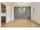 Elegant dining room featuring hardwood floors, a decorative chandelier, and a gray accent wall at 1395 Oconee Ne Pass, Brookhaven, GA 30319