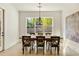 Bright dining room with large window, modern light fixture, and hardwood floors, great for entertaining at 1395 Oconee Ne Pass, Brookhaven, GA 30319