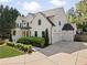 Elegant two-story white home with a three-car garage and beautiful landscaping at 1395 Oconee Ne Pass, Brookhaven, GA 30319