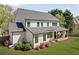 Rear exterior view of modern home showcasing a spacious backyard and covered patio ideal for outdoor enjoyment at 1395 Oconee Ne Pass, Brookhaven, GA 30319