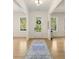 Bright foyer with hardwood floors, white walls, a decorative rug, and a view of the front door and windows at 1395 Oconee Ne Pass, Brookhaven, GA 30319