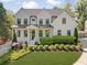 Charming two-story home with white siding, black-framed windows, manicured landscaping, and a well-maintained front yard at 1395 Oconee Ne Pass, Brookhaven, GA 30319