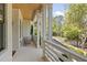 Inviting front porch featuring white painted brick, a wood ceiling, classic columns, and stylish outdoor furniture at 1395 Oconee Ne Pass, Brookhaven, GA 30319