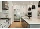 Bright and modern kitchen with stainless steel appliances, large island with sink, and light wood floors at 1395 Oconee Ne Pass, Brookhaven, GA 30319