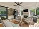 Covered patio featuring comfortable seating, an outdoor fireplace, and sliding glass doors at 1395 Oconee Ne Pass, Brookhaven, GA 30319