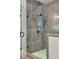 Modern bathroom featuring a glass-enclosed shower with gray tile and sleek fixtures at 1395 Oconee Ne Pass, Brookhaven, GA 30319