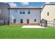 Expansive backyard view of a two-story home with well-manicured lawn at 2375 Walker Dr, Hampton, GA 30228