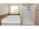 Bathroom with a large soaking tub with tile surround and a separate shower at 2375 Walker Dr, Hampton, GA 30228