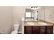 Bathroom featuring double sinks with granite countertop and dark cabinets at 2375 Walker Dr, Hampton, GA 30228