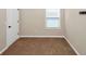 Carpeted bedroom features a window and white trim at 2375 Walker Dr, Hampton, GA 30228