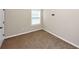 Cozy bedroom with neutral carpet, a window, and a door at 2375 Walker Dr, Hampton, GA 30228