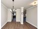 Open dining room with wood floors and a view into the kitchen area at 2375 Walker Dr, Hampton, GA 30228