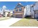 Beautiful two-story home showcasing a spacious driveway and lush green lawn at 2375 Walker Dr, Hampton, GA 30228