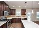 Modern kitchen with stainless steel appliances, countertops, and dark wood cabinets at 2375 Walker Dr, Hampton, GA 30228