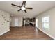 Open-concept living area featuring hardwood floors and a seamless transition to the kitchen at 2375 Walker Dr, Hampton, GA 30228