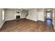 Cozy living room featuring a classic fireplace, hardwood floors, and staircase at 2375 Walker Dr, Hampton, GA 30228