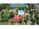 Aerial view of community amenities featuring a pool, tennis courts, and a clubhouse with a red roof at 326 Carmichael Cir, Canton, GA 30115