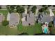 Aerial view of a well-maintained property with lush landscaping, mature trees, and a backyard pool at 326 Carmichael Cir, Canton, GA 30115