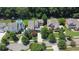 Aerial view of a home with mature trees, a well-manicured lawn, and a long driveway at 326 Carmichael Cir, Canton, GA 30115