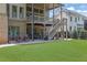 Expansive backyard featuring lush green lawn, patio with outdoor seating, and a charming two-story deck at 326 Carmichael Cir, Canton, GA 30115
