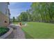 Serene backyard featuring a stone firepit, colorful Adirondack chairs, and a lush green lawn at 326 Carmichael Cir, Canton, GA 30115