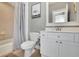 Clean bathroom features a tub/shower combination, a white vanity, toilet, and tile floor, maximizing space and functionality at 326 Carmichael Cir, Canton, GA 30115