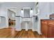 Elegant bathroom features a pedestal sink, wood floors, and well-lit mirror, offering a blend of style and functionality at 326 Carmichael Cir, Canton, GA 30115