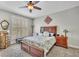 Cozy bedroom showcasing a dark wood bed frame with floral bedding and carpeted floor at 326 Carmichael Cir, Canton, GA 30115