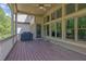 Spacious covered deck with wood floors, ceiling fan, and a grill, perfect for relaxing and entertaining at 326 Carmichael Cir, Canton, GA 30115