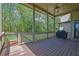 Enjoy the outdoors on this covered deck featuring wood floors, a ceiling fan, and a grill at 326 Carmichael Cir, Canton, GA 30115