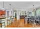 Spacious dining area connected to the kitchen and living room featuring hardwood floors and modern lighting at 326 Carmichael Cir, Canton, GA 30115