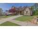 Beautiful two-story home features manicured lawn, brick accents, and charming front porch at 326 Carmichael Cir, Canton, GA 30115