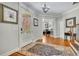 Inviting foyer with hardwood floors, elegant rug, and views of the staircase and study at 326 Carmichael Cir, Canton, GA 30115