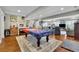 Large game room with an American flag pool table and hardwood flooring at 326 Carmichael Cir, Canton, GA 30115