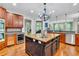 Well-equipped kitchen featuring a kitchen island, stainless steel appliances, and ample cabinet space at 326 Carmichael Cir, Canton, GA 30115