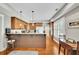 Open kitchen features dark wood cabinetry, stainless steel appliances, a center island, and adjacent breakfast nook at 326 Carmichael Cir, Canton, GA 30115