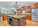 Spacious kitchen with wooden floors, a large island with sink, and stainless steel refrigerator at 326 Carmichael Cir, Canton, GA 30115