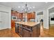 Bright kitchen with hardwood floors, a large center island with a sink, and white cabinets at 326 Carmichael Cir, Canton, GA 30115