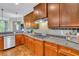 Kitchen with granite countertops, stainless steel appliances, and wood cabinets at 326 Carmichael Cir, Canton, GA 30115