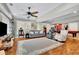Inviting living room features wood flooring, a large rug, comfortable seating, and natural light at 326 Carmichael Cir, Canton, GA 30115