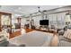 Elegant living room with wood floors, detailed rug, and multiple seating areas around entertainment center at 326 Carmichael Cir, Canton, GA 30115
