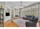 Spacious living room featuring a brick fireplace, large windows, and hardwood flooring at 326 Carmichael Cir, Canton, GA 30115