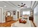 Spacious main bedroom features tray ceilings, wood floors, and ensuite bathroom at 326 Carmichael Cir, Canton, GA 30115
