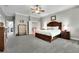 Spacious main bedroom with two dressers, large bed, and view of the stairs at 326 Carmichael Cir, Canton, GA 30115